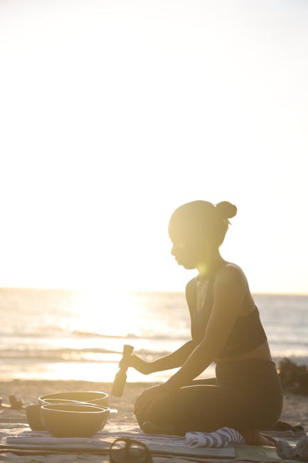 Silhouette of a person meditating peacefully at sunset